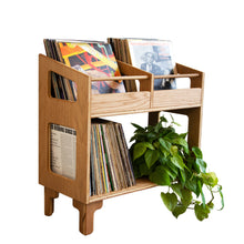 Load image into Gallery viewer, Wooden record player stand with vinyl records and a plant on a white background