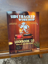 Load image into Gallery viewer, Book titled 'SideTracked Workshop Lookbook 25' on a wooden surface
