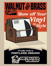 Load image into Gallery viewer, Advertisement for Walnut & Brass vinyl record storage, featuring a wooden record holder with records and text about Portland, Oregon.
