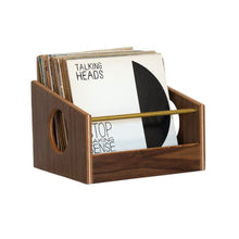 Load image into Gallery viewer, A walnut wood vinyl record crate with brass accents, containing several records, placed on a white background.
