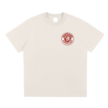 Load image into Gallery viewer, Beige t-shirt with a red logo on a white background