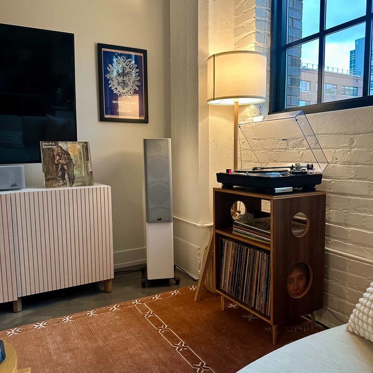 Living room with a record player, lamp, and television.