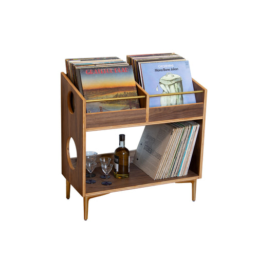 Wooden record player stand with records and a bottle on a white background