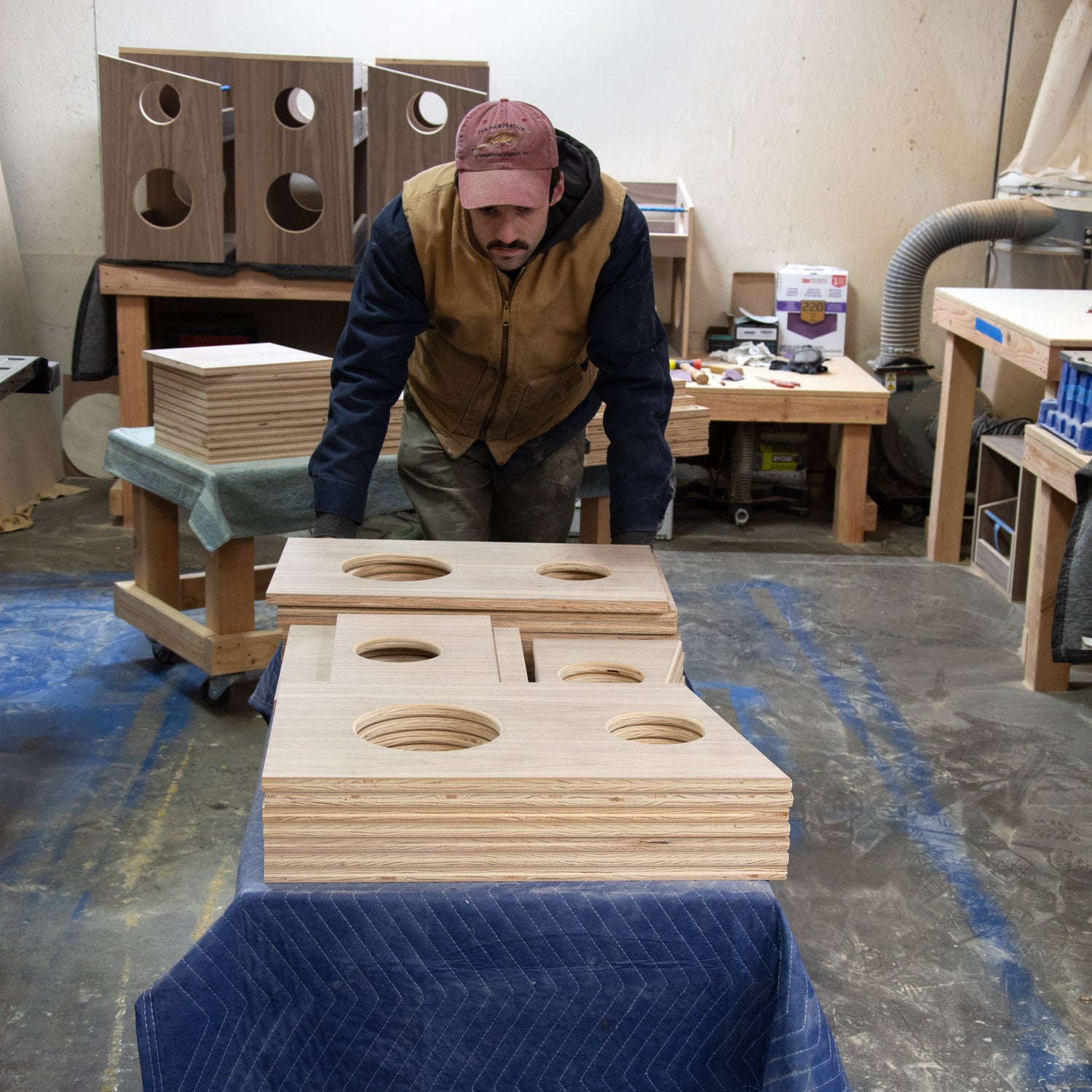 worker pushing cart of wooden furniture  parts 
