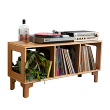Load image into Gallery viewer, Wooden record player console with vinyl records and a bottle on a white background
