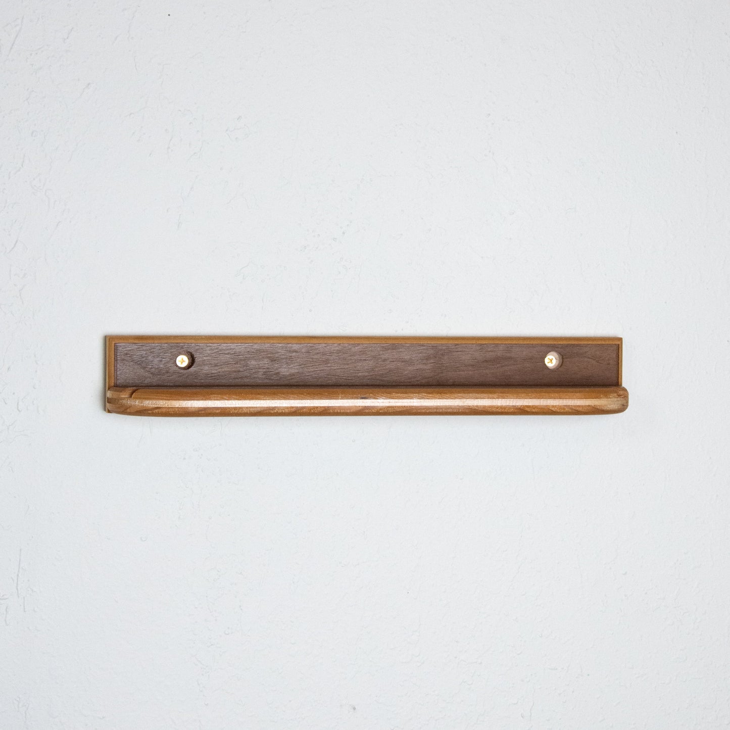 Wooden walnut record display shelf on white wall