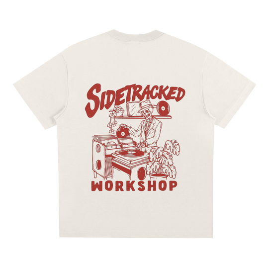 White t-shirt with red graphic and text 'Sidetracked Workshop' on a white background